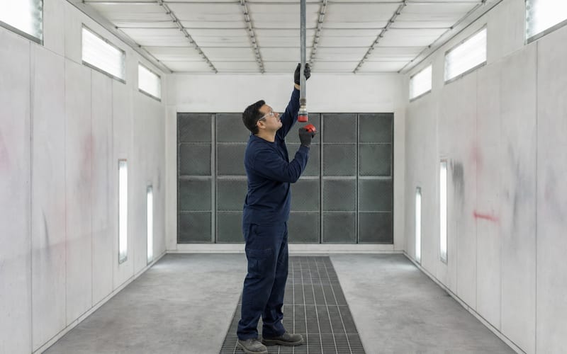Suppression nozzles inside a spray finishing booth